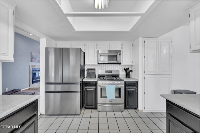 6101 Via Suerte Ave, El Paso, TX 79912 - kitchen with stainless steel appliances, light tile patterned flooring, light countertops, and white cabinetry