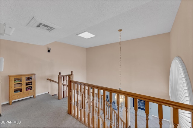 6101 Via Suerte Ave, El Paso, TX 79912 - corridor with an upstairs landing, carpet floors, baseboards, and a textured ceiling