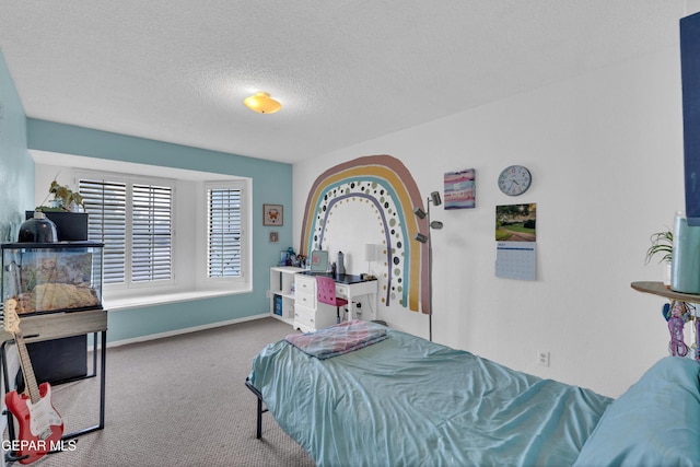 6101 Via Suerte Ave, El Paso, TX 79912 - carpeted bedroom with a textured ceiling and baseboards