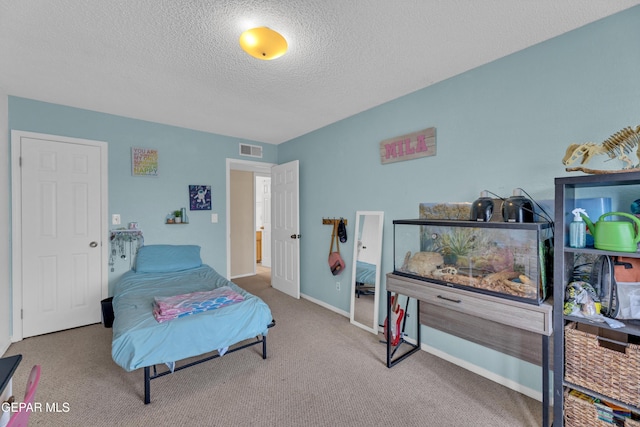 6101 Via Suerte Ave, El Paso, TX 79912 - bedroom with a textured ceiling, carpet, and baseboards