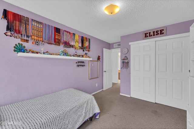 6101 Via Suerte Ave, El Paso, TX 79912 - carpeted bedroom featuring a textured ceiling, a closet, and baseboards