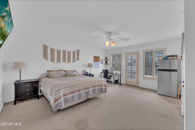 6101 Via Suerte Ave, El Paso, TX 79912 - carpeted bedroom with freestanding refrigerator, access to outside, and a ceiling fan