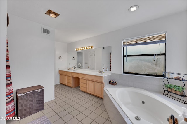 6101 Via Suerte Ave, El Paso, TX 79912 - bathroom with double vanity, a whirlpool tub, and tile patterned floors