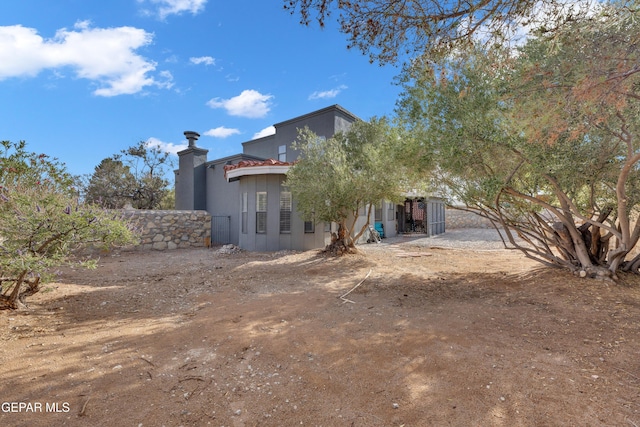 6101 Via Suerte Ave, El Paso, TX 79912 - rear view of house with a chimney