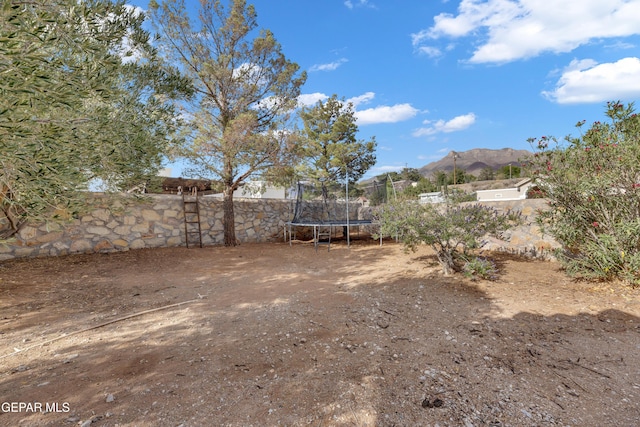 6101 Via Suerte Ave, El Paso, TX 79912 - fenced backyard with a trampoline and a mountain view