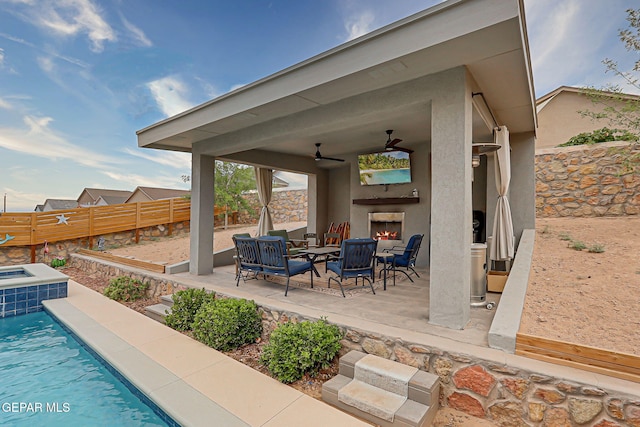 12749 Iron Falls Dr, Horizon City, TX 79928 - fenced backyard with a patio, an outdoor living space with a fireplace, and ceiling fan