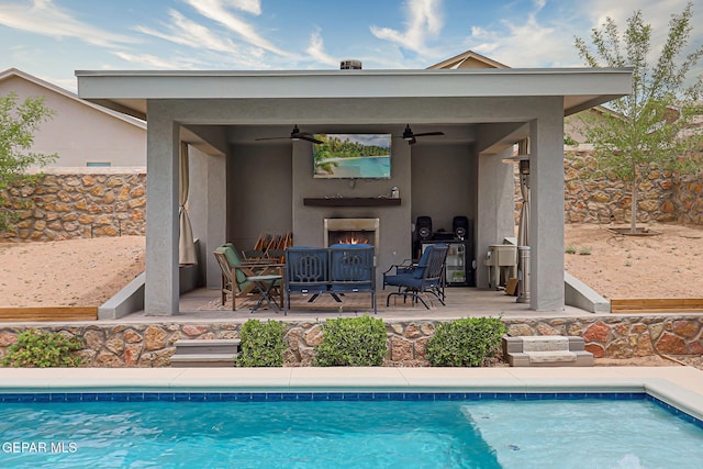 12749 Iron Falls Dr, Horizon City, TX 79928 - view of swimming pool with ceiling fan and an outdoor living space with a fireplace