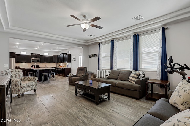 12749 Iron Falls Dr, Horizon City, TX 79928 - living room featuring ceiling fan, a raised ceiling, and recessed lighting