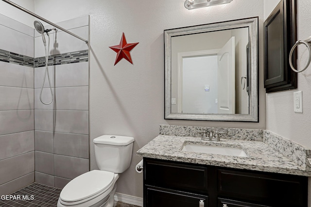 12749 Iron Falls Dr, Horizon City, TX 79928 - full bathroom featuring vanity, toilet, and a tile shower