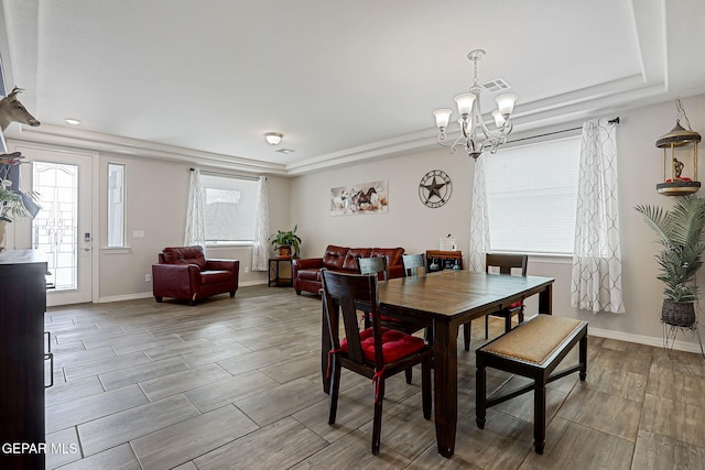 12749 Iron Falls Dr, Horizon City, TX 79928 - dining room with a chandelier, a raised ceiling, baseboards, recessed lighting, and wood finished floors