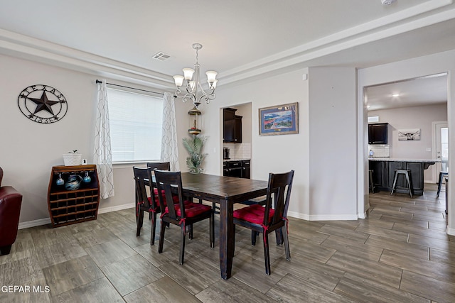 12749 Iron Falls Dr, Horizon City, TX 79928 - dining space with wood tiled floors, a chandelier, and baseboards