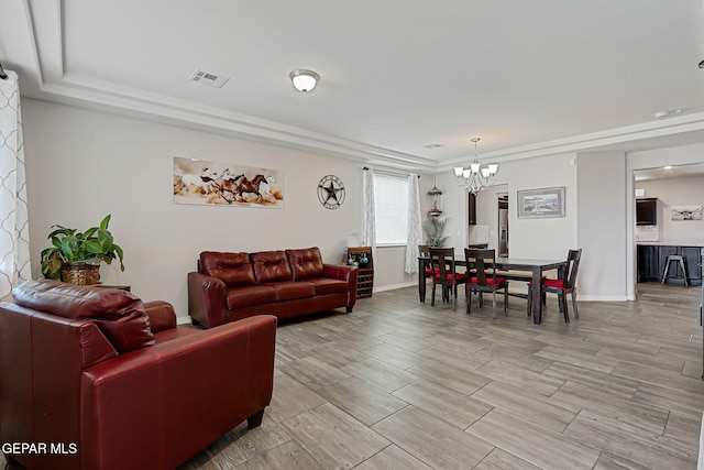 12749 Iron Falls Dr, Horizon City, TX 79928 - living room with a chandelier, baseboards, wood finish floors, and a tray ceiling