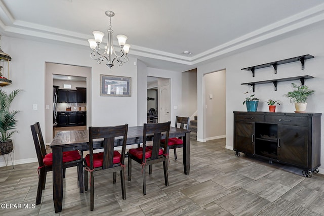 12749 Iron Falls Dr, Horizon City, TX 79928 - dining area with a tray ceiling, a chandelier, stairway, and baseboards