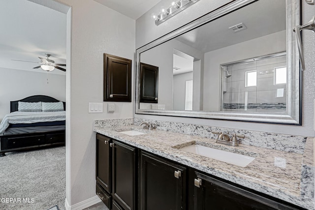 12749 Iron Falls Dr, Horizon City, TX 79928 - ensuite bathroom with double vanity, ceiling fan, and baseboards