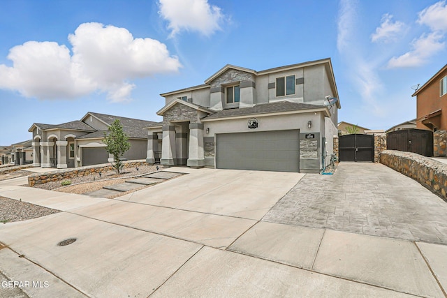 12749 Iron Falls Dr, Horizon City, TX 79928 - view of front of property featuring a gate, stucco siding, concrete driveway, an attached garage, and stone siding