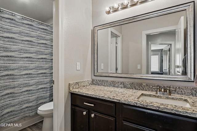 12749 Iron Falls Dr, Horizon City, TX 79928 - full bath with vanity, toilet, and wood finished floors