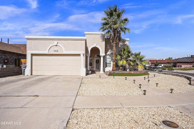 11973 Regal Banner Ln, El Paso, TX 79936 - mediterranean / spanish-style house featuring concrete driveway, a garage, and stucco siding