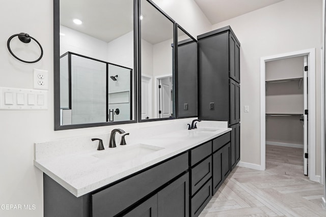 13351 Jeff Winton Dr, El Paso, TX 79928 - full bathroom with a shower stall, double vanity, a spacious closet, and baseboards