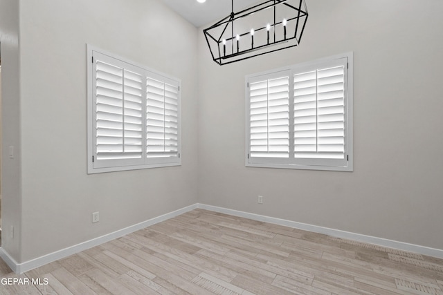 13351 Jeff Winton Dr, El Paso, TX 79928 - unfurnished dining area featuring a chandelier, wood finished floors, and baseboards