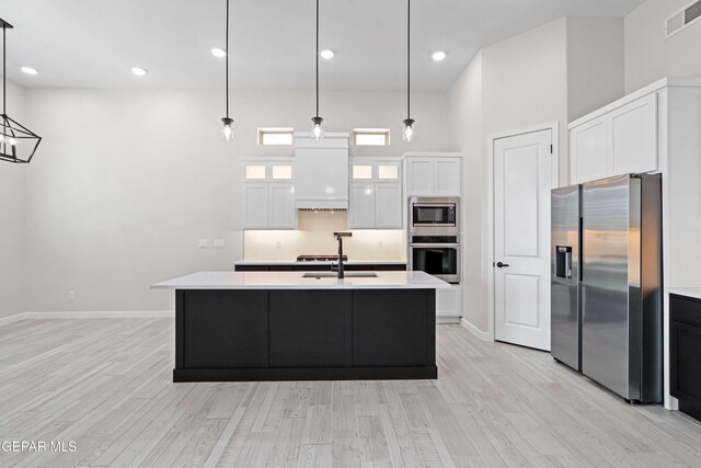 13351 Jeff Winton Dr, El Paso, TX 79928 - kitchen with stainless steel appliances, a sink, light wood-type flooring, light countertops, and baseboards