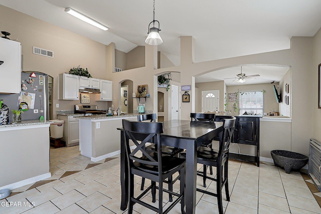 11840 Balladeer Ave, El Paso, TX 79936 - dining room featuring a ceiling fan, light tile patterned floors, arched walkways, and high vaulted ceiling