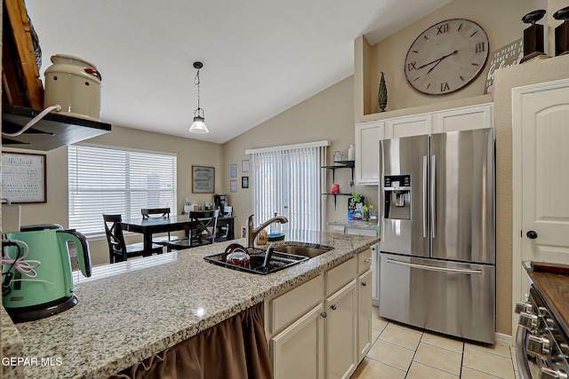 11840 Balladeer Ave, El Paso, TX 79936 - kitchen featuring stainless steel fridge, a sink, lofted ceiling, light tile patterned floors, and white cabinetry