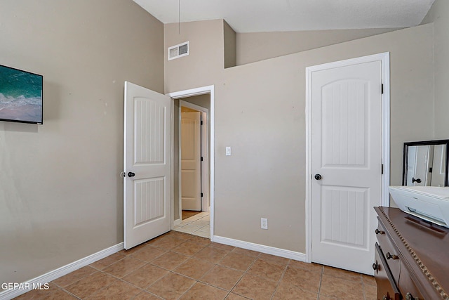 11840 Balladeer Ave, El Paso, TX 79936 - bedroom featuring baseboards, light tile patterned flooring, and high vaulted ceiling