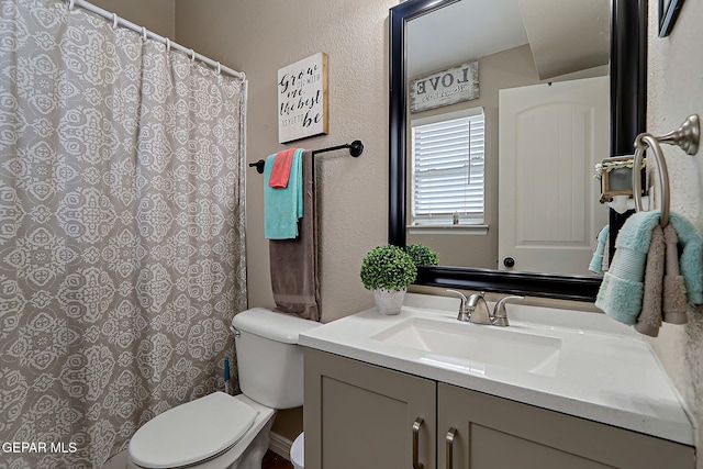 11840 Balladeer Ave, El Paso, TX 79936 - full bathroom featuring vanity, toilet, a textured wall, and a shower with curtain
