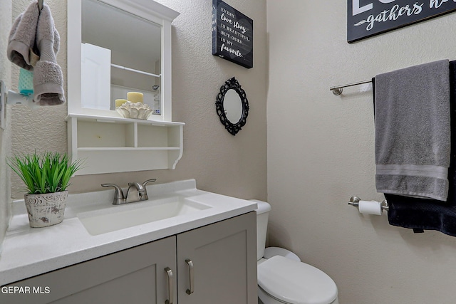 11840 Balladeer Ave, El Paso, TX 79936 - full bath with toilet, vanity, a shower, and a textured wall