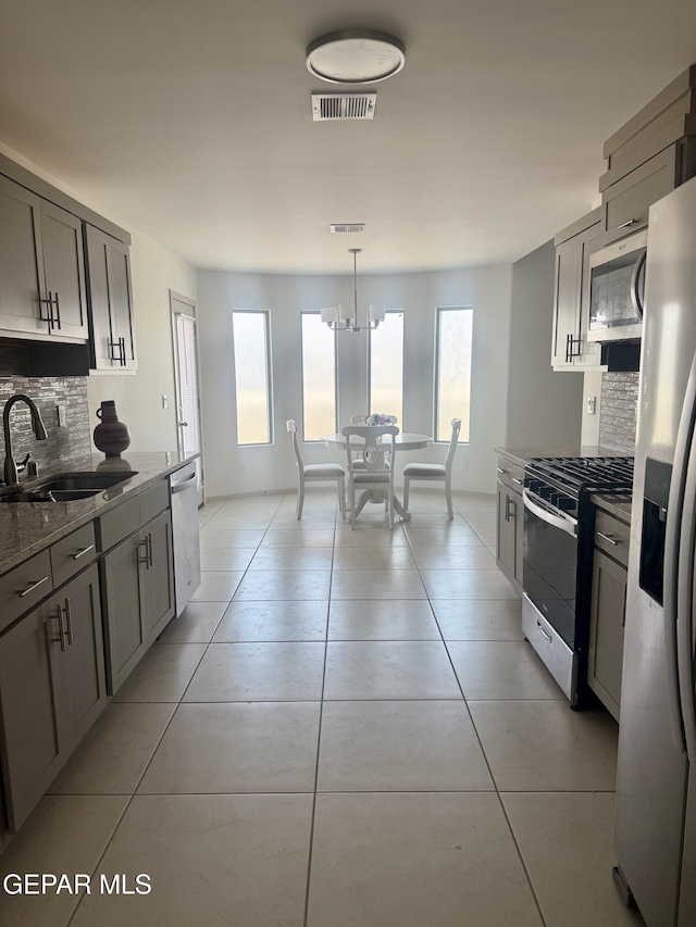 13862 Paseo Bosque Ave, El Paso, TX 79928 - kitchen with stainless steel appliances, a sink, decorative backsplash, and healthy amount of natural light