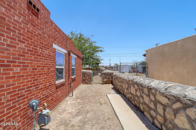 264 Edith Dr, El Paso, TX 79915 - view of home's exterior with a gate and brick siding