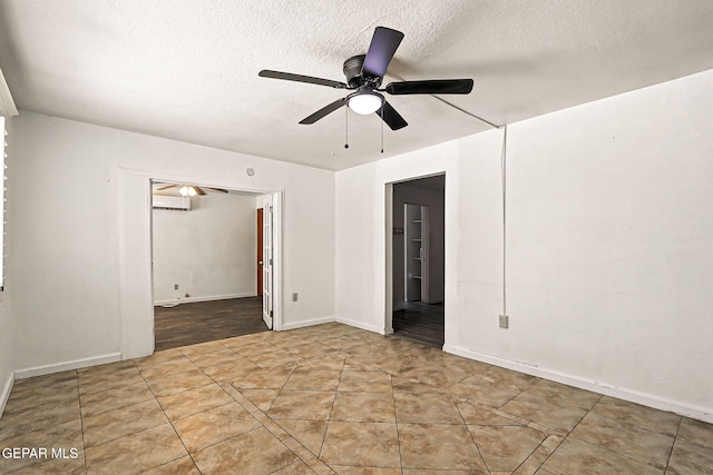 264 Edith Dr, El Paso, TX 79915 - tiled empty room with a textured ceiling, a ceiling fan, and a wall unit AC