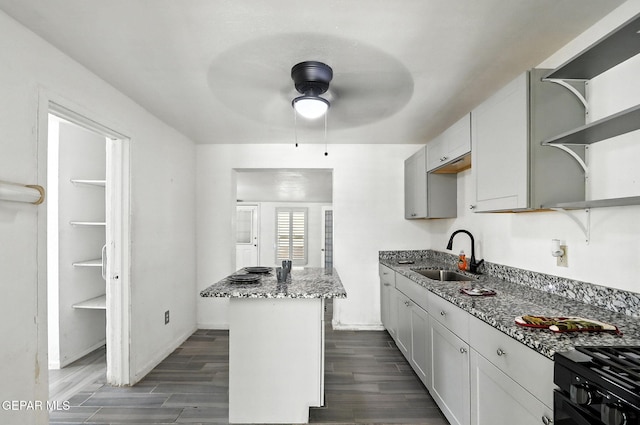 264 Edith Dr, El Paso, TX 79915 - kitchen featuring open shelves, ceiling fan, a center island, stone countertops, and dark wood finished floors