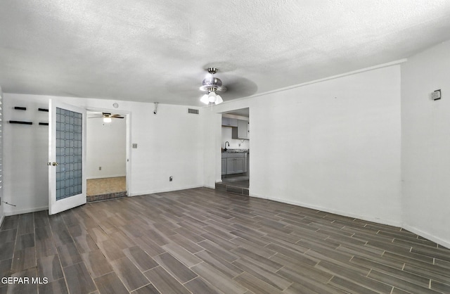 264 Edith Dr, El Paso, TX 79915 - unfurnished living room featuring a ceiling fan, dark wood finished floors, and a textured ceiling