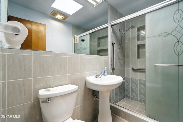 264 Edith Dr, El Paso, TX 79915 - bathroom featuring tile walls, a shower stall, and decorative backsplash
