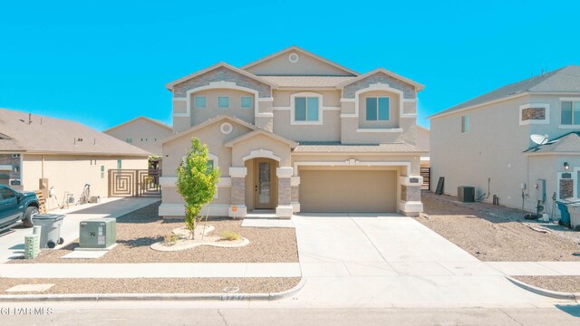 14737 Tierra Escape Ave, El Paso, TX 79938 - view of front of property with stucco siding, an attached garage, concrete driveway, stone siding, and a gate