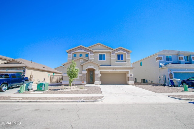14737 Tierra Escape Ave, El Paso, TX 79938 - view of front facade with an attached garage, stucco siding, driveway, and stone siding