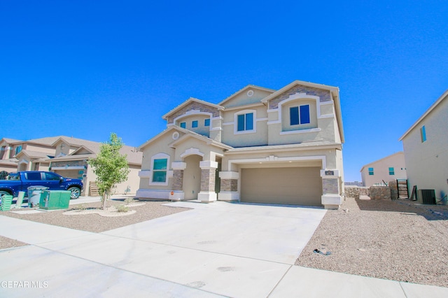 14737 Tierra Escape Ave, El Paso, TX 79938 - view of front of house with stucco siding, an attached garage, concrete driveway, and stone siding
