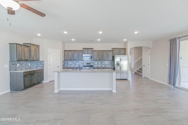 14737 Tierra Escape Ave, El Paso, TX 79938 - kitchen featuring appliances with stainless steel finishes, tasteful backsplash, recessed lighting, arched walkways, and a ceiling fan