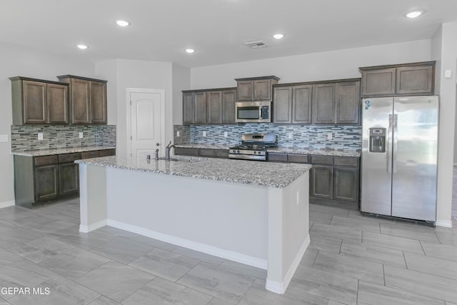 14737 Tierra Escape Ave, El Paso, TX 79938 - kitchen featuring stainless steel appliances, backsplash, dark brown cabinetry, and recessed lighting
