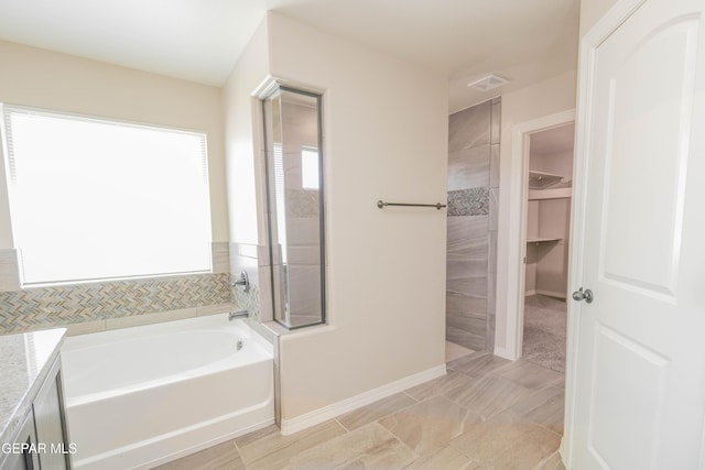14737 Tierra Escape Ave, El Paso, TX 79938 - bathroom featuring a bath, vanity, tiled shower, and a spacious closet