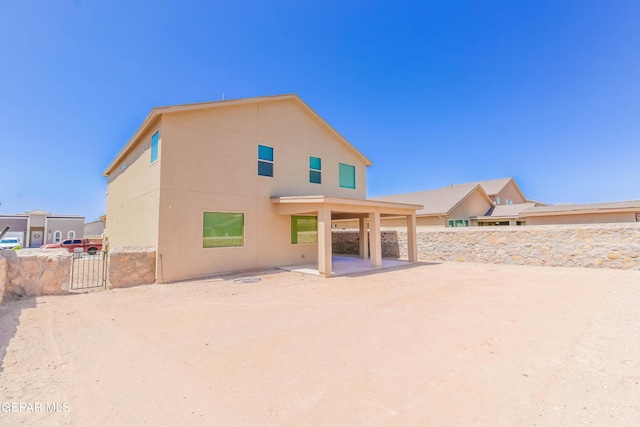 14737 Tierra Escape Ave, El Paso, TX 79938 - back of house featuring a patio area, a fenced backyard, stucco siding, and a gate