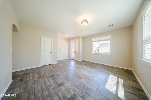 12320 Desert Path Ct, El Paso, TX 79938 - spare room featuring arched walkways, wood finished floors, and baseboards