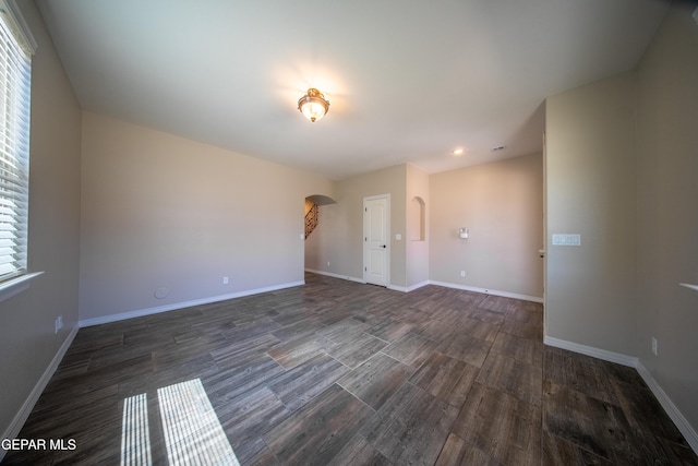 12320 Desert Path Ct, El Paso, TX 79938 - spare room featuring arched walkways, dark wood finished floors, baseboards, and recessed lighting