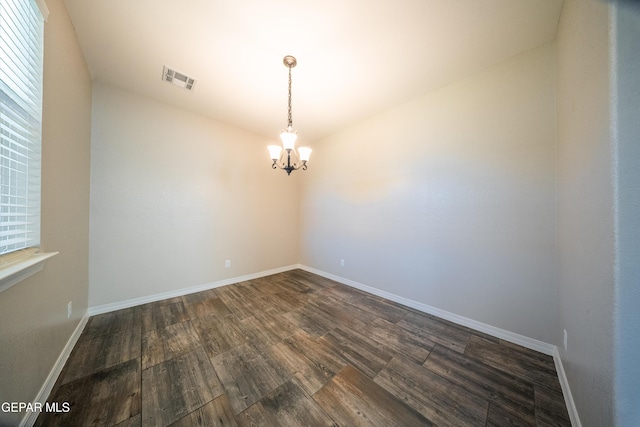 12320 Desert Path Ct, El Paso, TX 79938 - empty room with a chandelier, dark wood finished floors, baseboards, and healthy amount of natural light