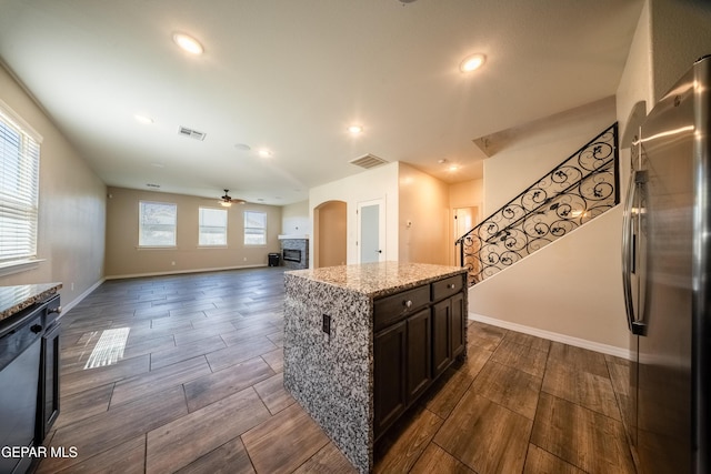 12320 Desert Path Ct, El Paso, TX 79938 - kitchen featuring freestanding refrigerator, arched walkways, wood finish floors, baseboards, and recessed lighting