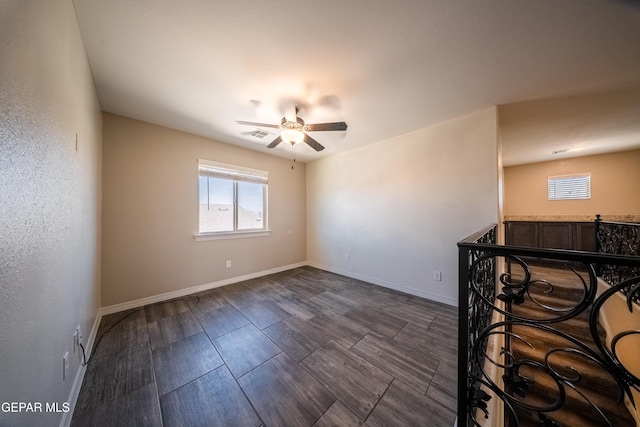 12320 Desert Path Ct, El Paso, TX 79938 - empty room with a ceiling fan, baseboards, and dark wood-type flooring