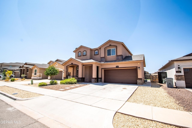 12320 Desert Path Ct, El Paso, TX 79938 - mediterranean / spanish-style house featuring stucco siding, concrete driveway, stone siding, an attached garage, and a gate