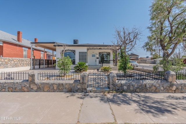3427 Hamilton Ave, El Paso, TX 79930 - view of front of house with a carport, covered porch, a fenced front yard, a gate, and concrete driveway