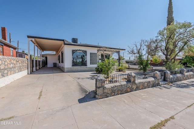 3427 Hamilton Ave, El Paso, TX 79930 - rear view of property with stucco siding, a carport, and driveway